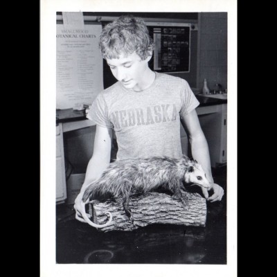 A young Gray Staab proudly admiring his taxidermied opossum. 