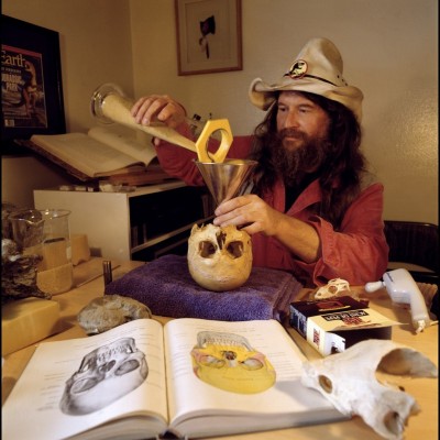 Bob Bakker taking the measure of Cope's brain size by pouring pasta noodles into his noodle. &copy; Louie Psihoyos 1994