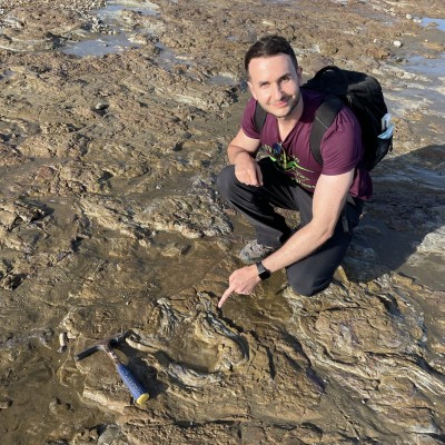 Studying a theropod footprint on the beach at Sandown, Isle of Wight. 2021.